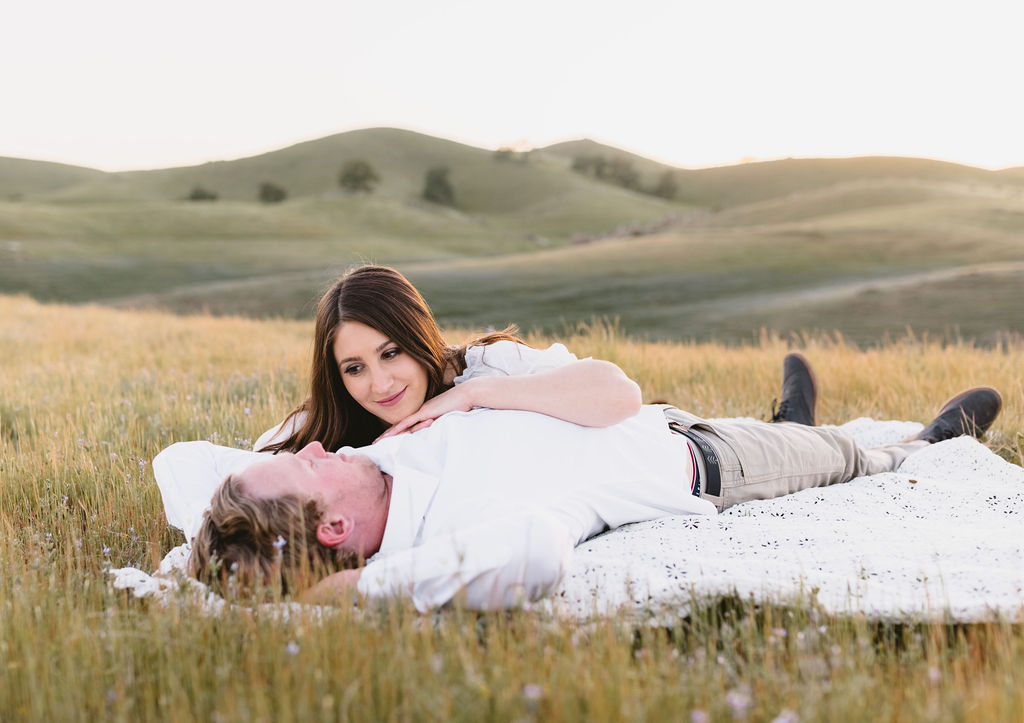 Women laying on mans chest during photoshoot in CA