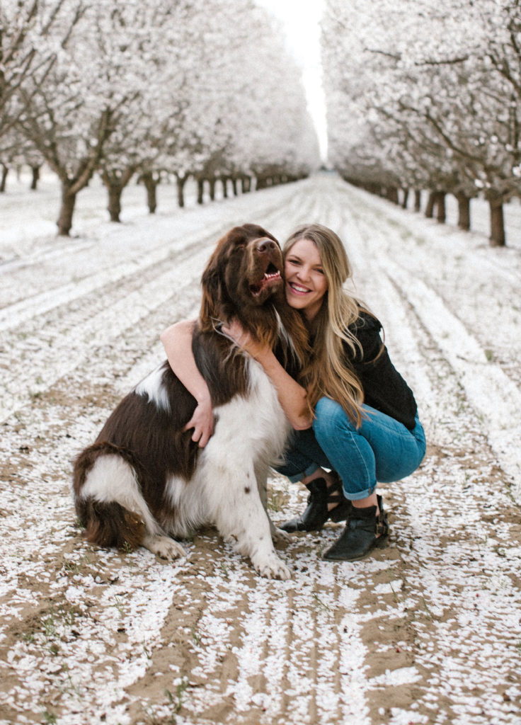 woman and dog posing for spring photos
