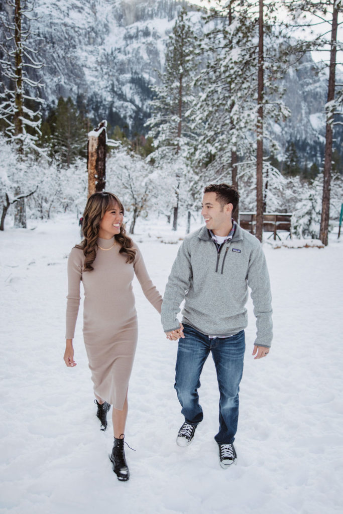Couple posing for maternity photos during the winter in Yosemite National Park