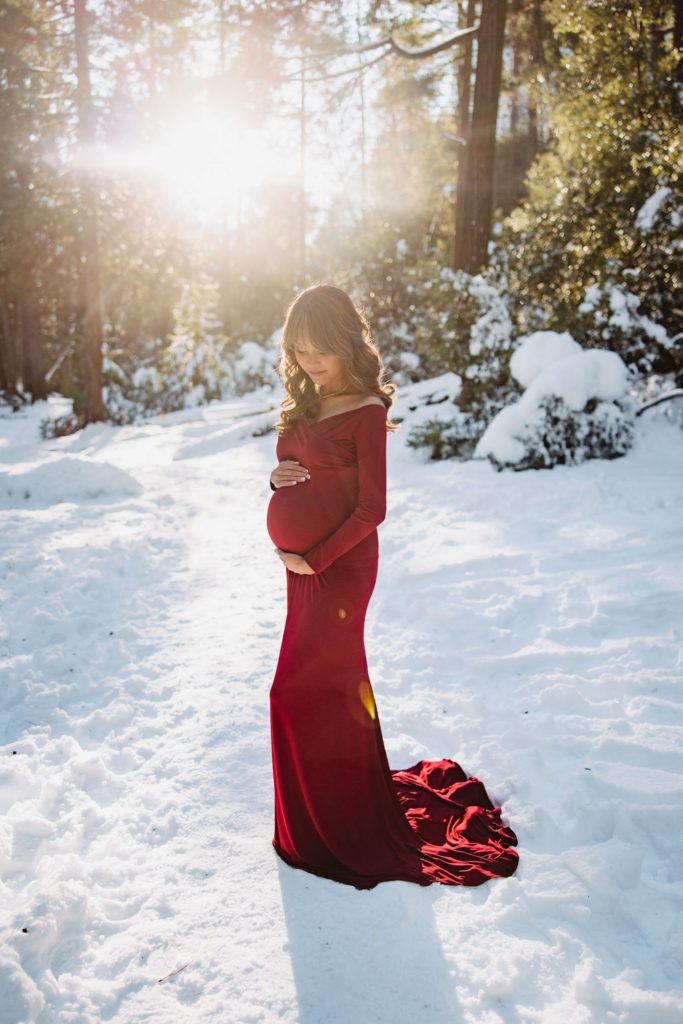 Woman posing for winter maternity photos