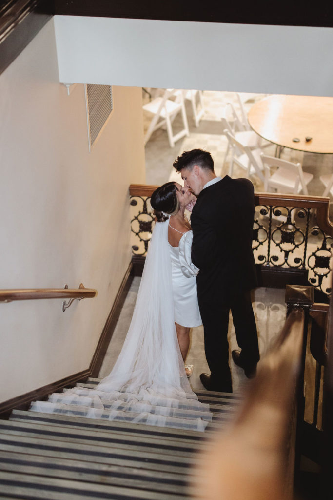 Bride and groom walking down the stairs at The Grand 1401