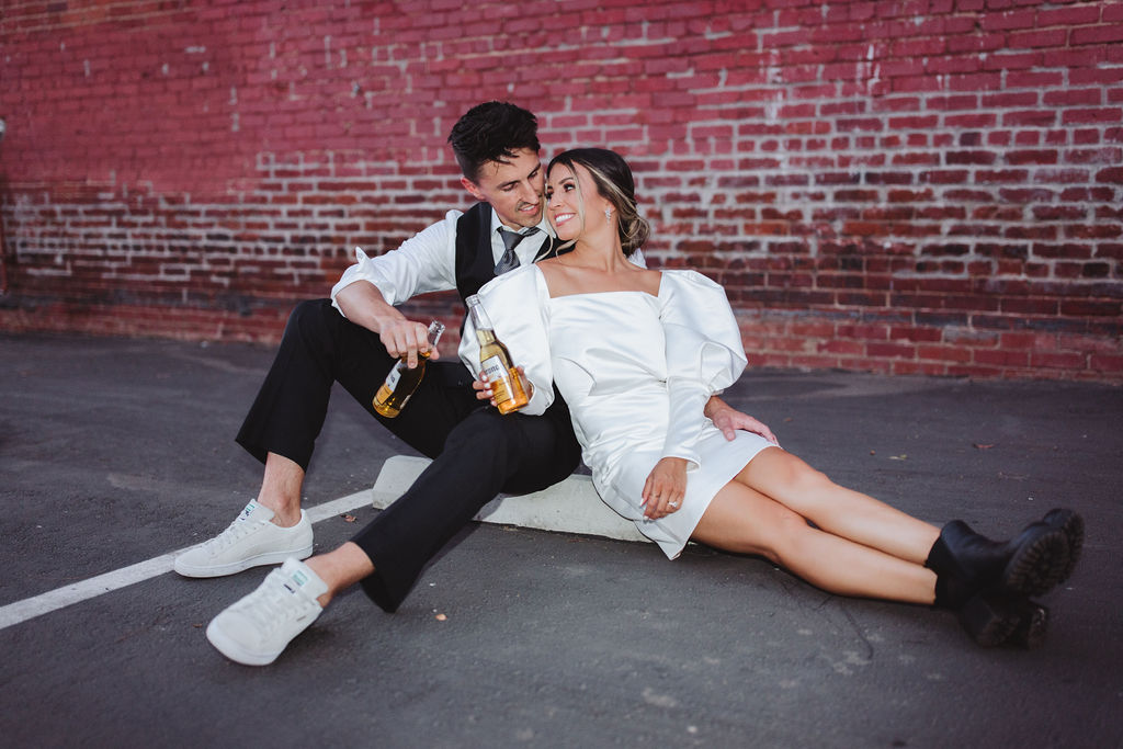 Bride and groom drinking coronas