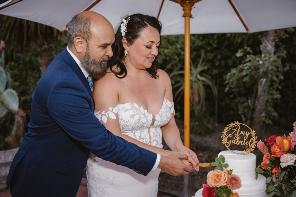 Bride and groom cutting cake - wedding photography package