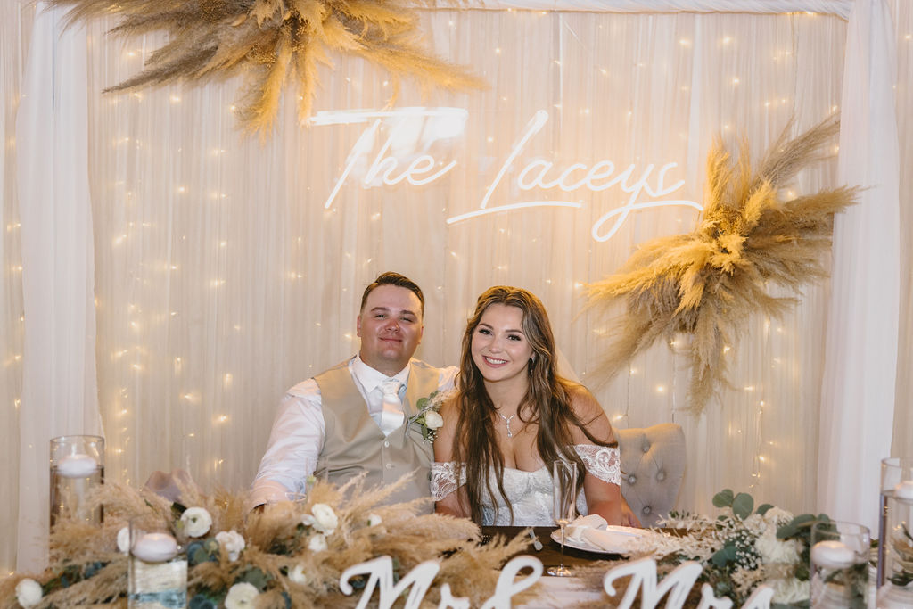 Bride and groom at boho sweetheart table