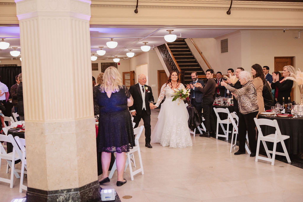 Bride and groom entering wedding reception