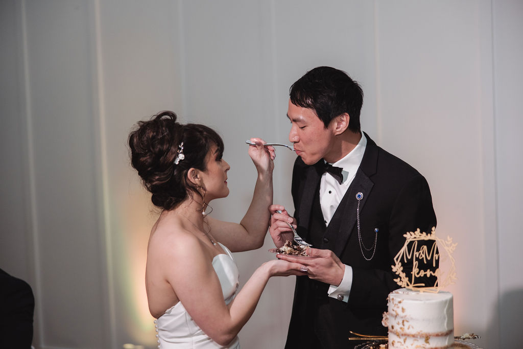 bride and groom tasting wedding cake