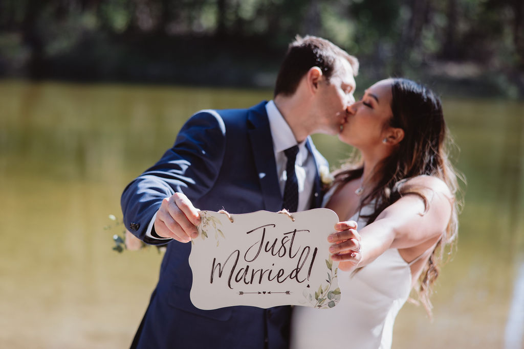 bride and groom elopement photos with just married sign
