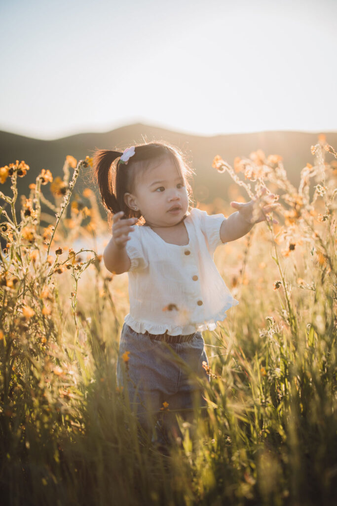 Child walking through wildflowers