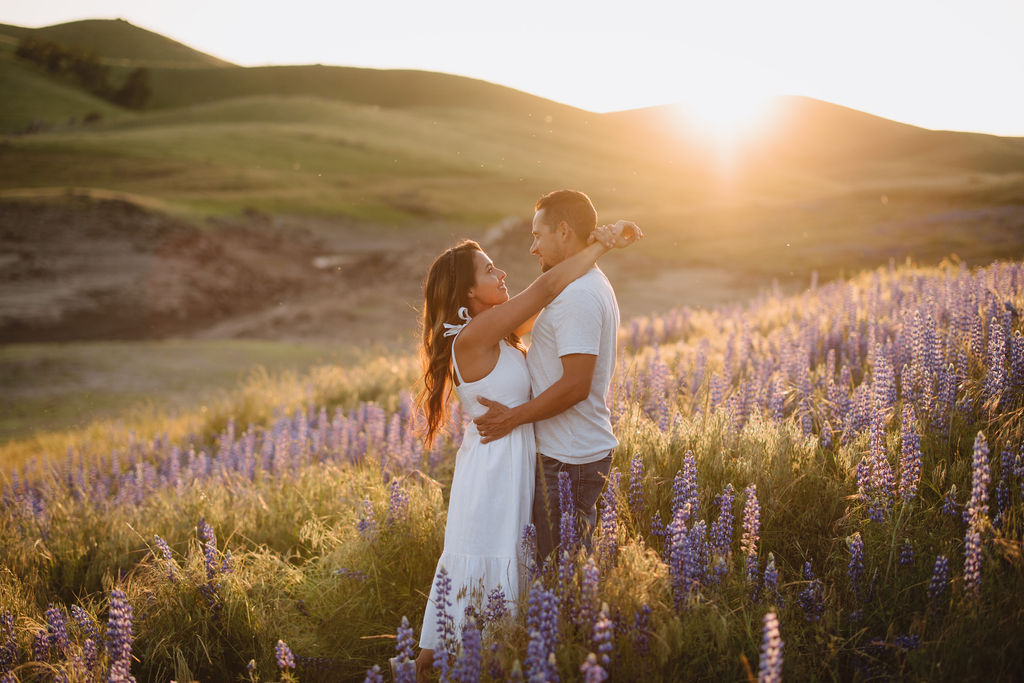 couple posing for photos during sunset