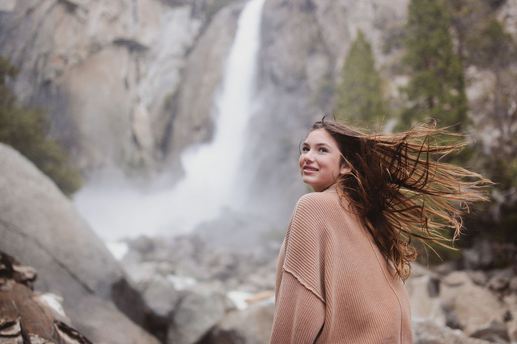 girl in front of waterfall