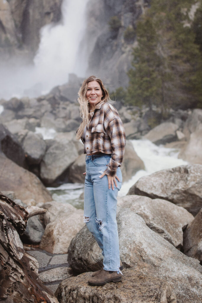 woman posing by waterfall