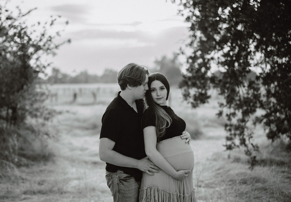 Couple posing for outdoor photoshoot during pregnancy