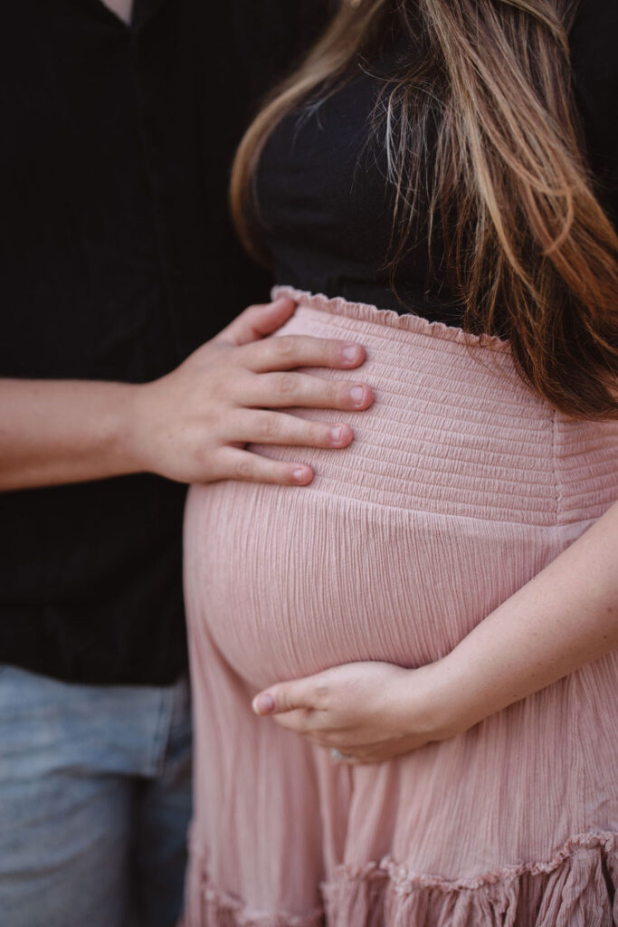 Woman and man holding pregnant belly