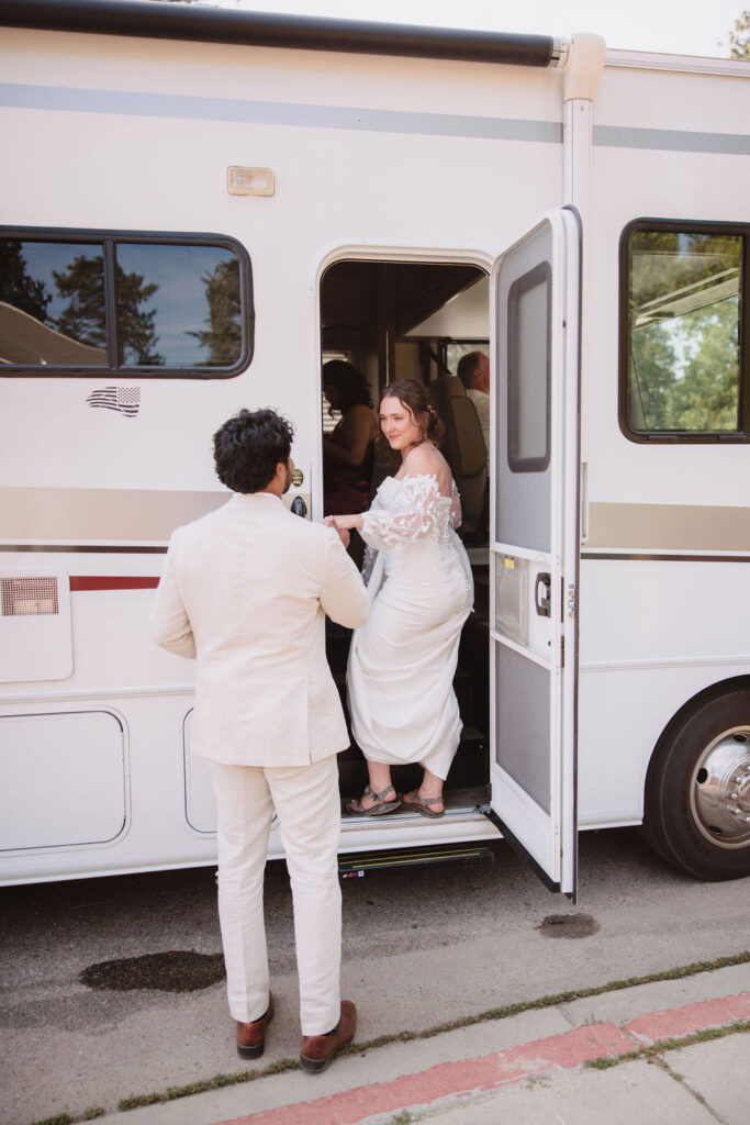 Bride and groom getting into RV