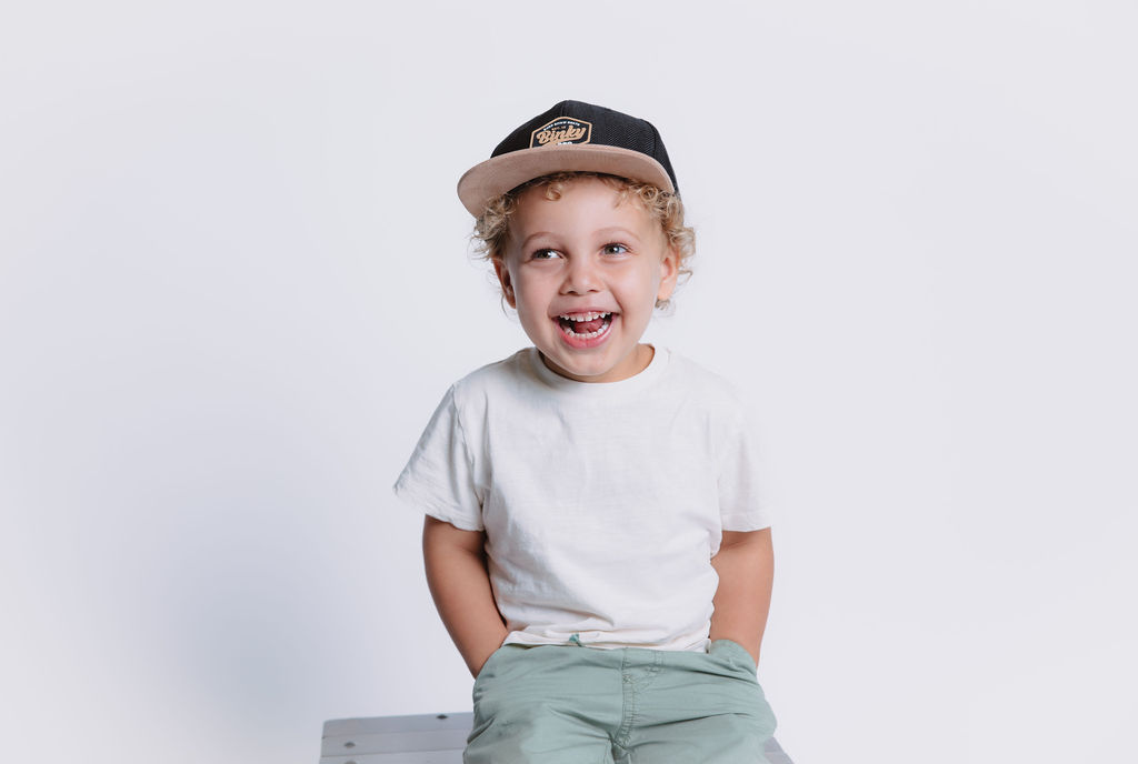 Little boy posing for in studio portraits