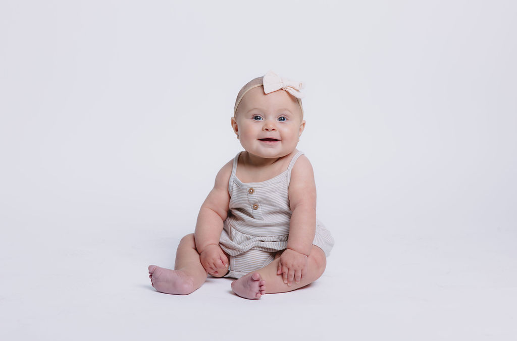 Baby girl posing for photos in studio