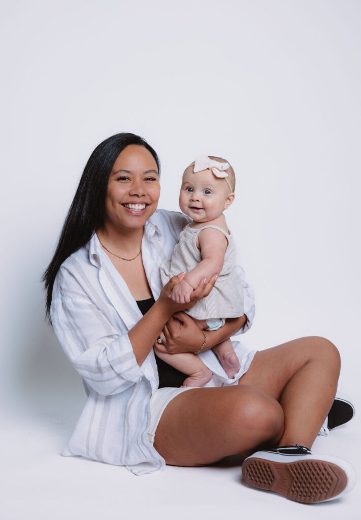 Mother holding baby girl for photos