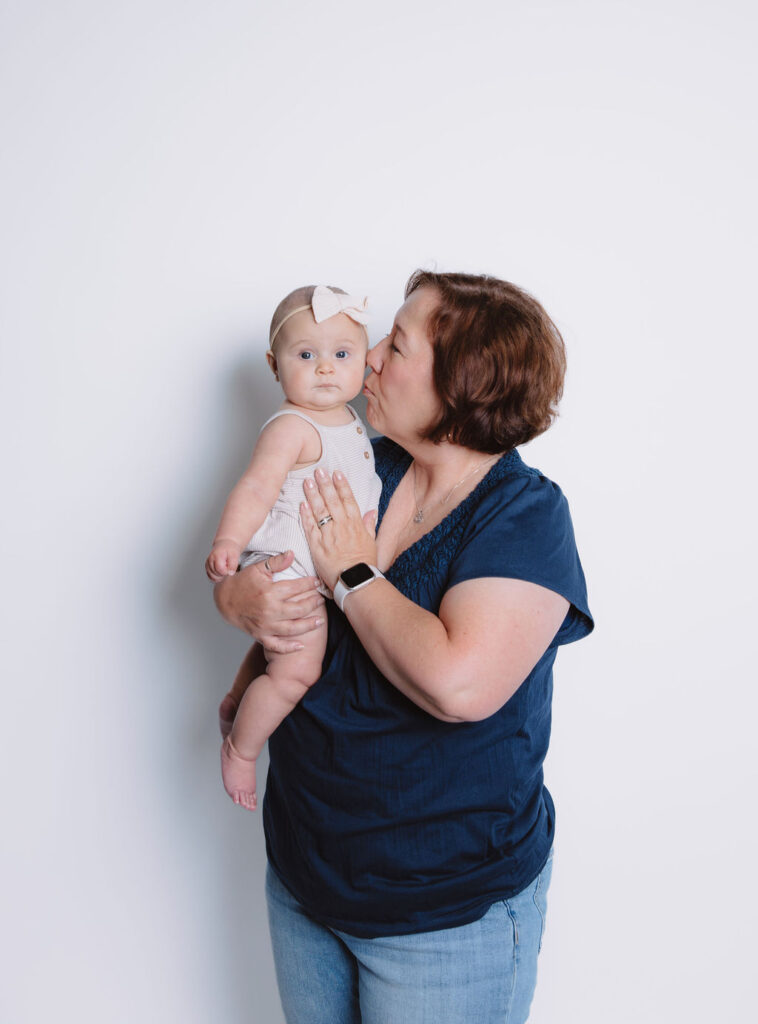 Grandmother holding baby girl for photos