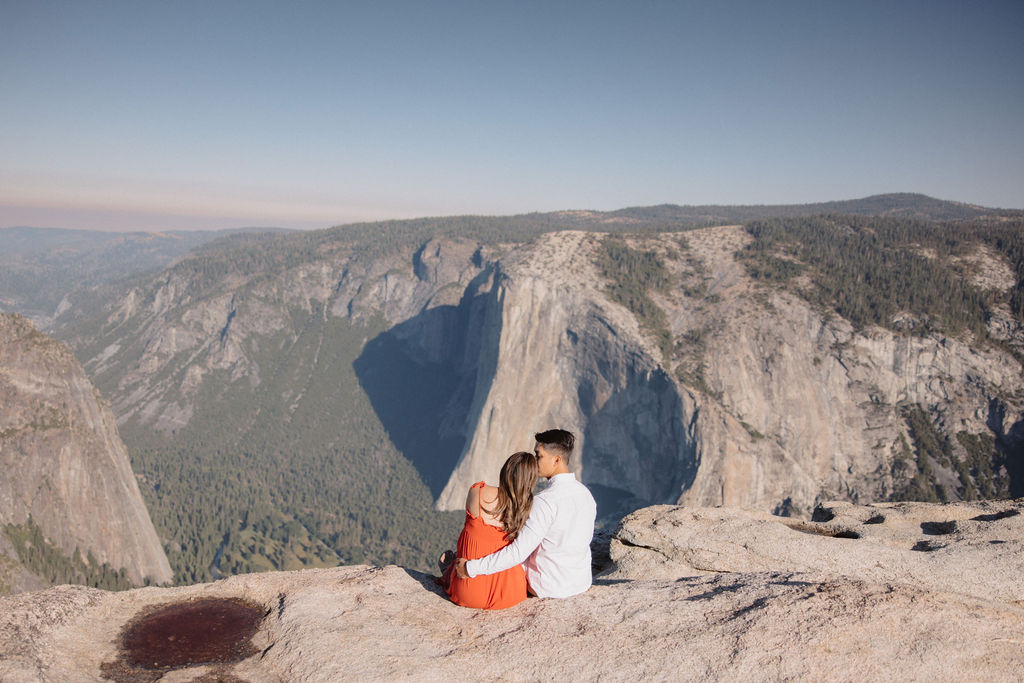 Couple posing for maternity session at Taft Point in Yosemite