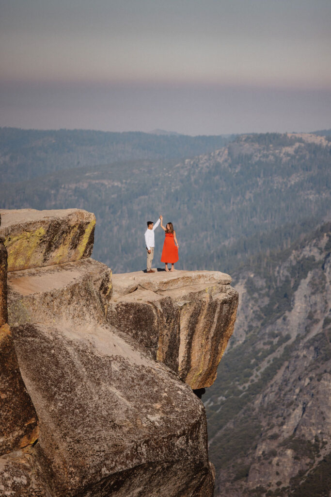 Couple posing for photos at Taft Point in Yosemite National Park
