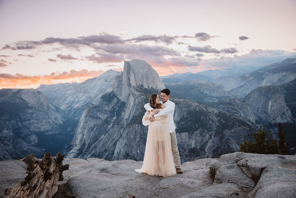 Couple posing for maternity session at Glacier Point in Yosemite National Park