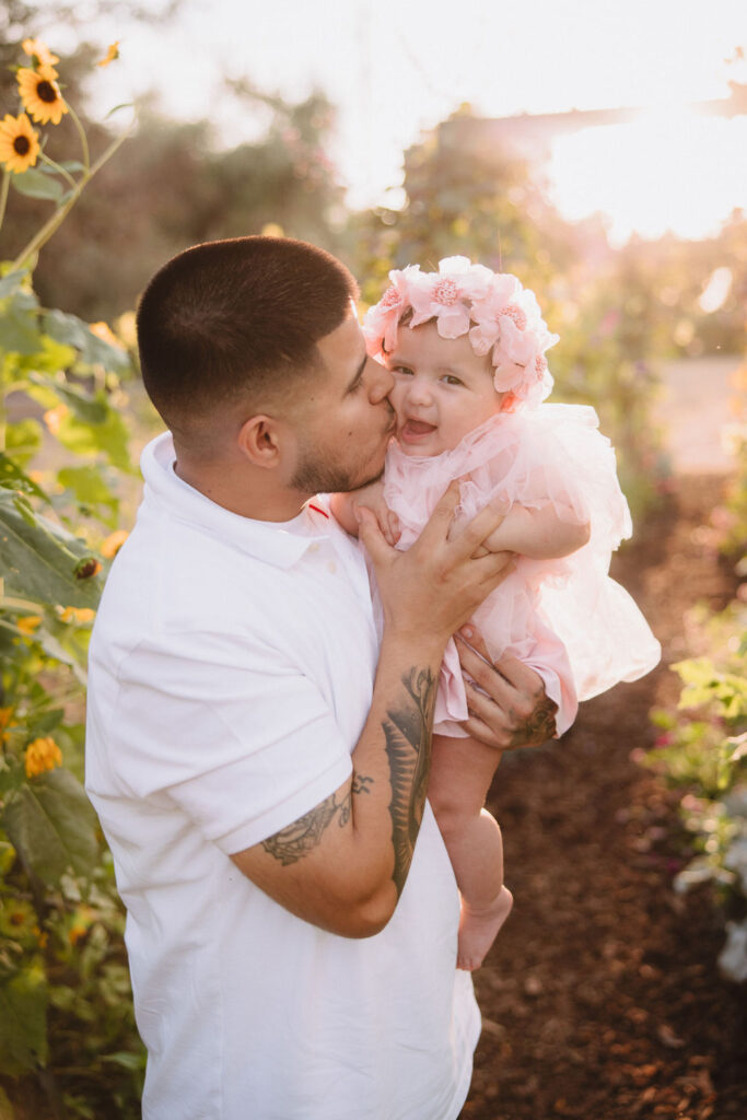 dad and daughter in flower garden