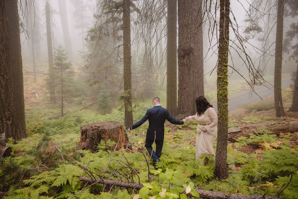 Bride and groom walking in the forest
