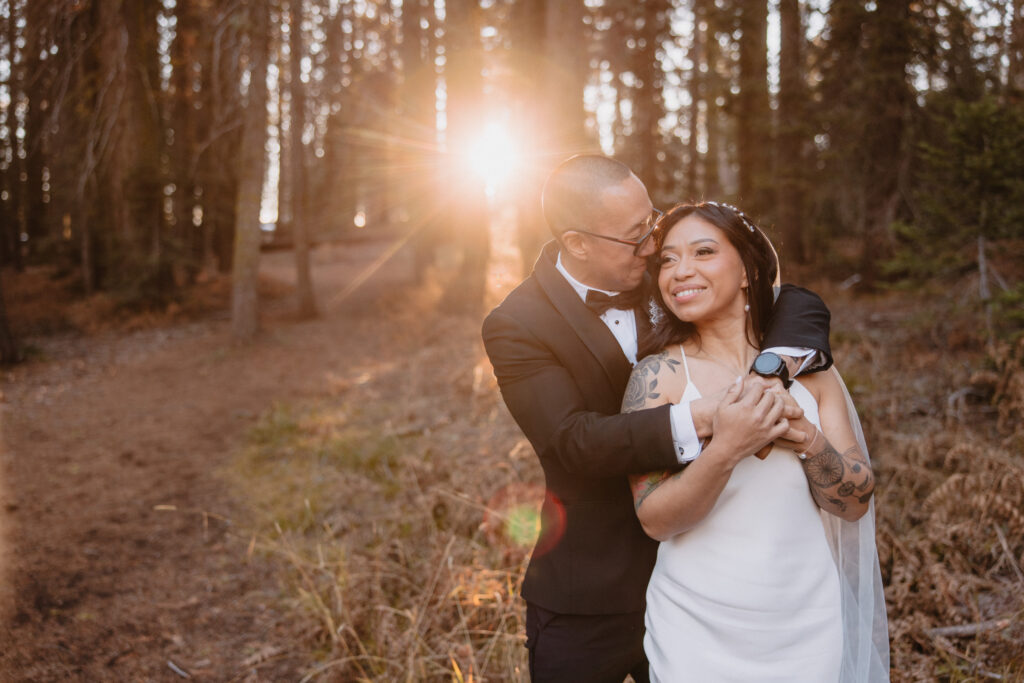 Bride and groom posing in the woods in sequoia national forest after their intimate elopement