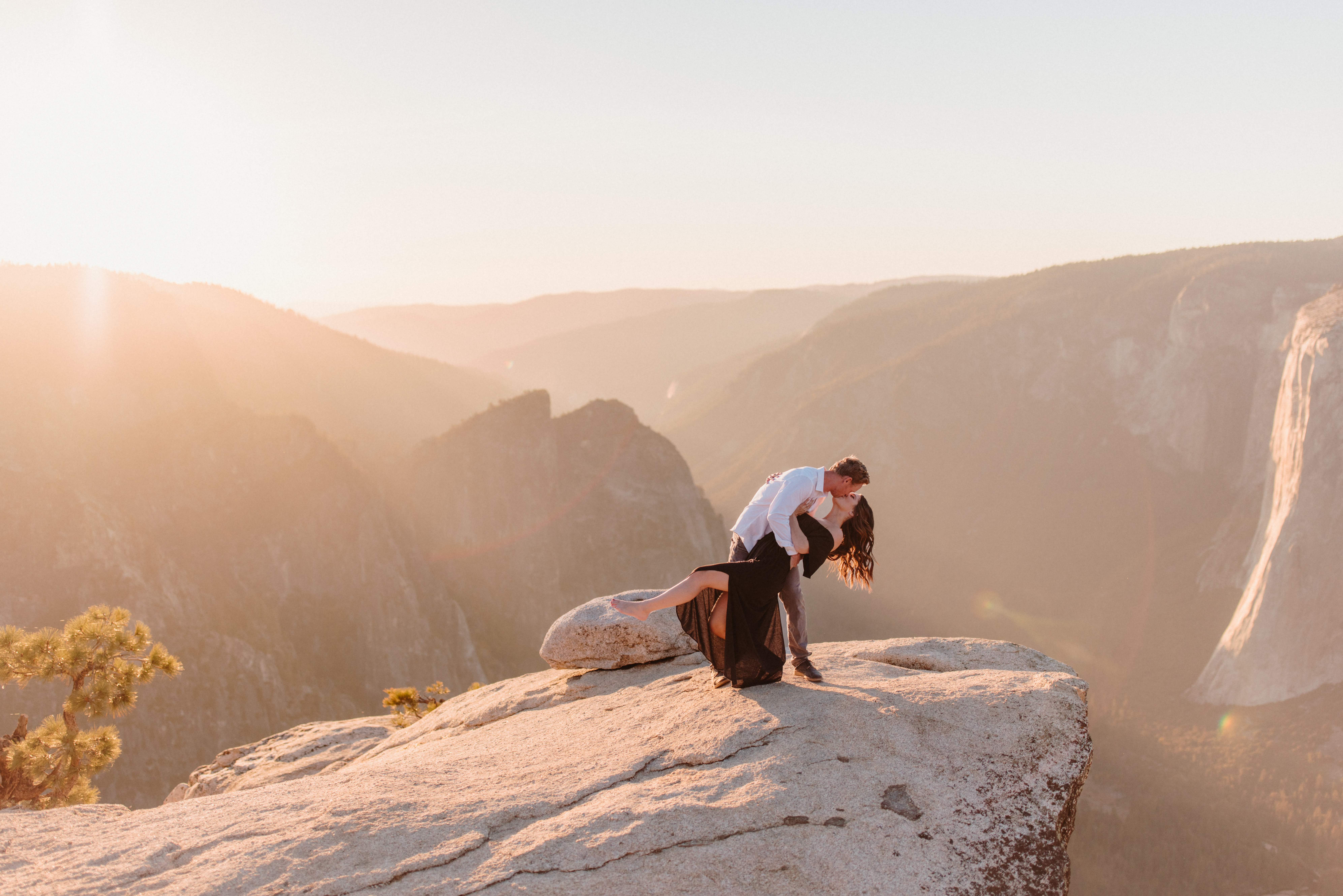 Couple dipping during their engagement photos at Taft Point in Yosemite National Park