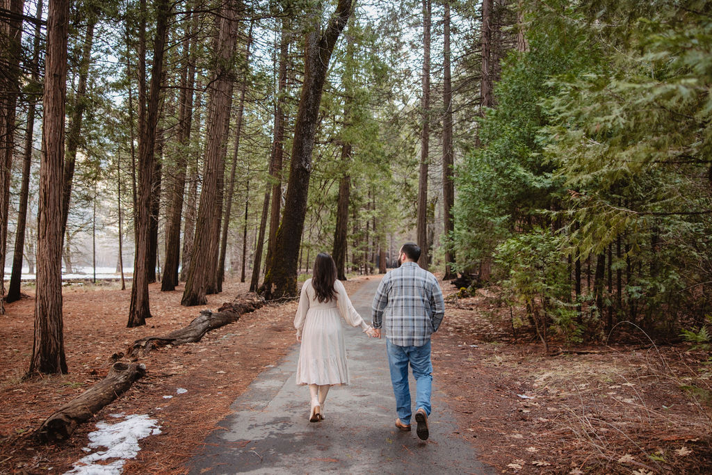 Man and woman walking in the forest of Yosemite