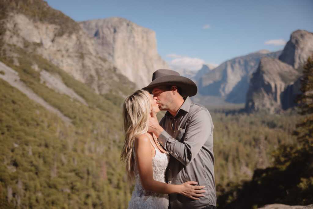 Bride and groom kissing in front of Tunnel view