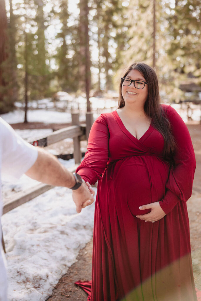 Pregnant woman posing for photos outdoors