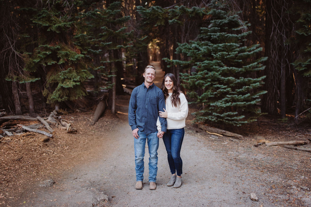 Couple posing for photos on a trail
