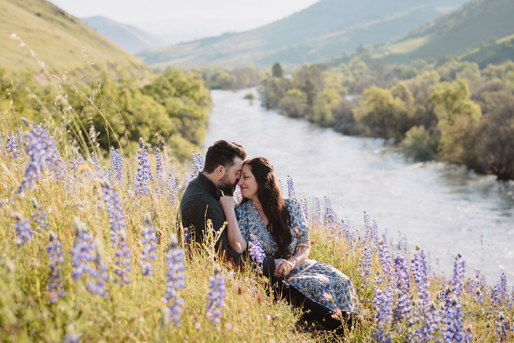 outdoor spring engagement photos | couple holding each other in field