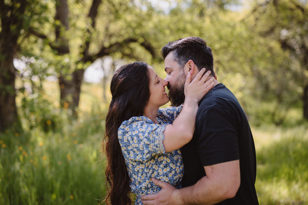 outdoor spring engagement photos | couple kissing during couples session at winton park