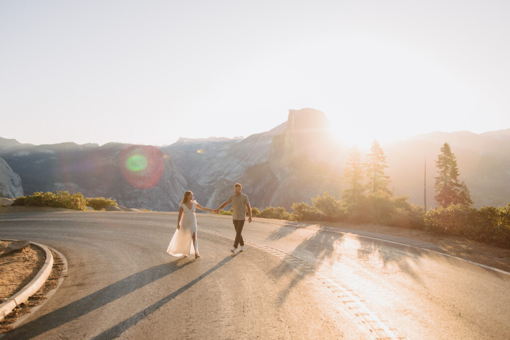 Couple walking on the road at a switch back at glacier point at sunrise. 