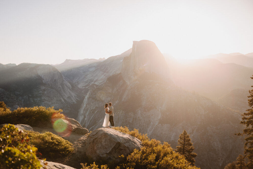 Couple at glacier point in yosemite at sunrise. Beautiful dreamy photography