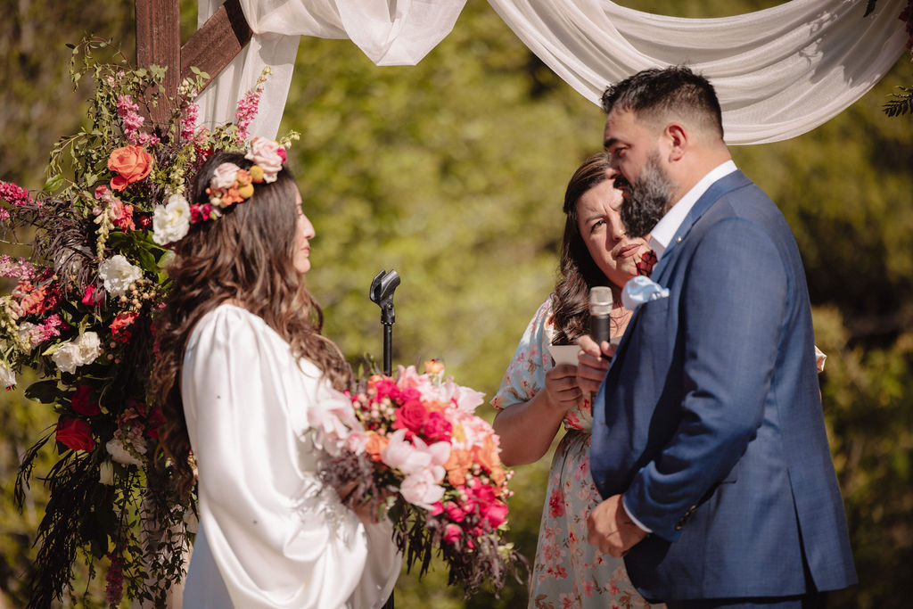 bride and groom posing for their outdoor wedding photos
