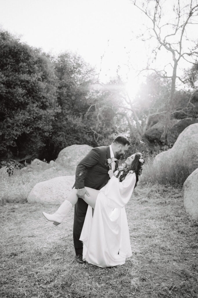 bride and groom posing for their outdoor wedding photos
