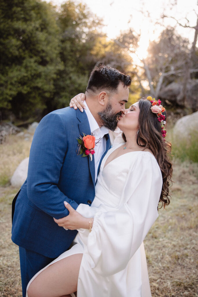 bride and groom posing for their outdoor wedding photos
