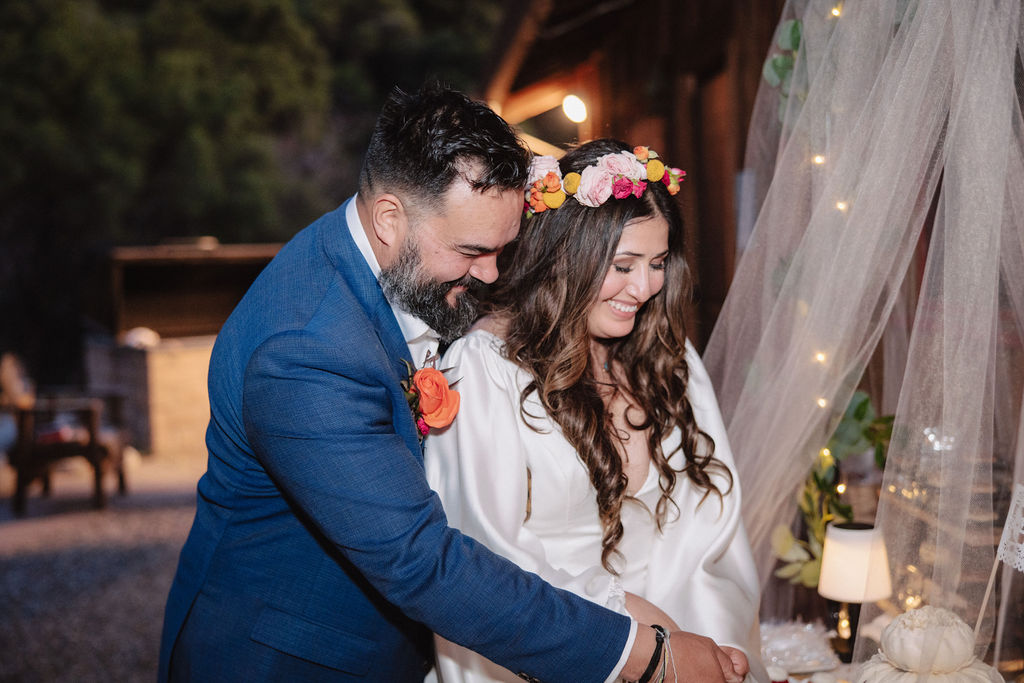 bride and groom posing for their outdoor wedding photos
