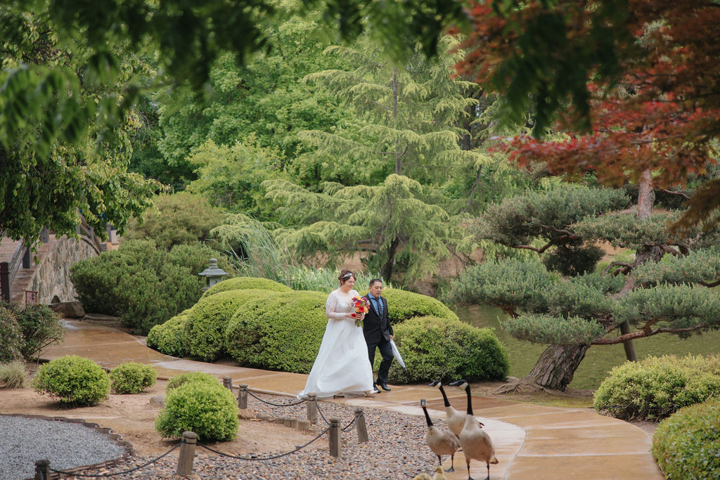 bride and groom posing for their wedding portraits
