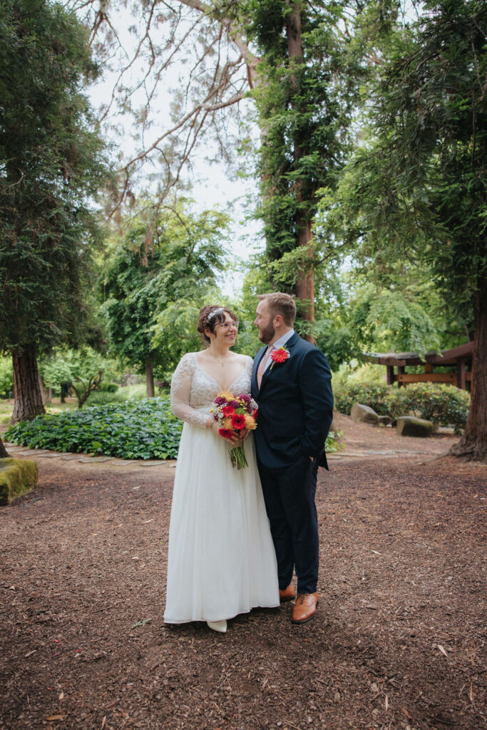 bride and groom posing for their wedding portraits
