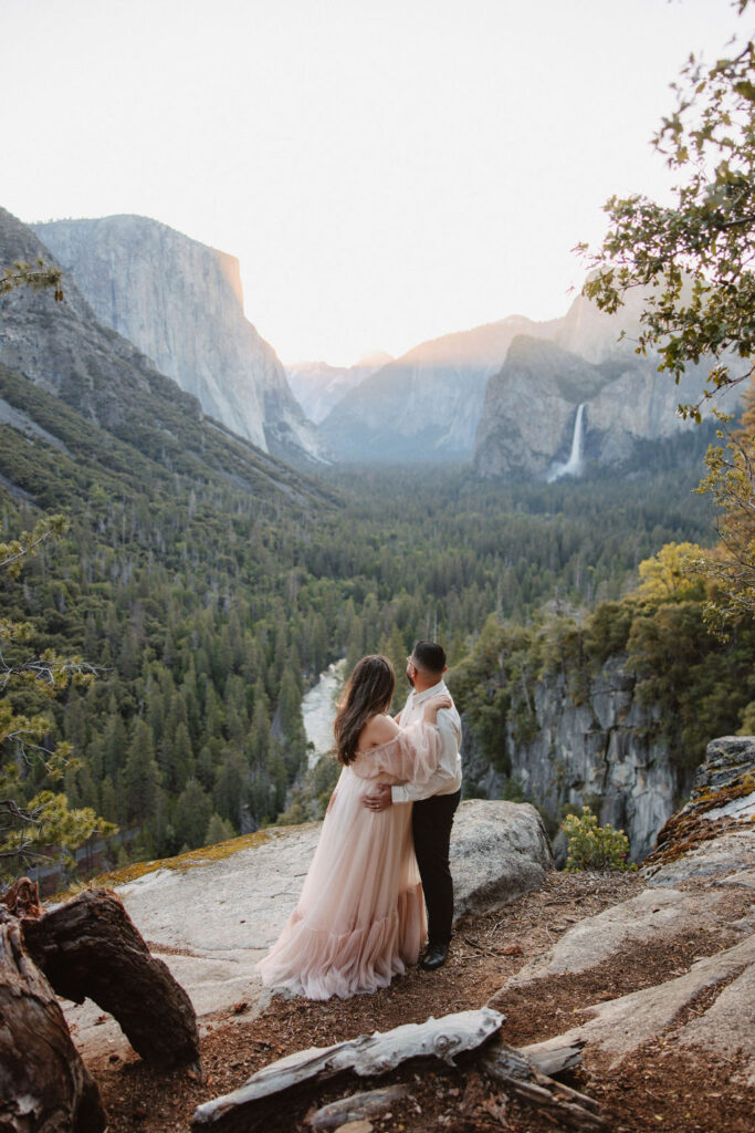 couple posing in the mountains for their family photos
