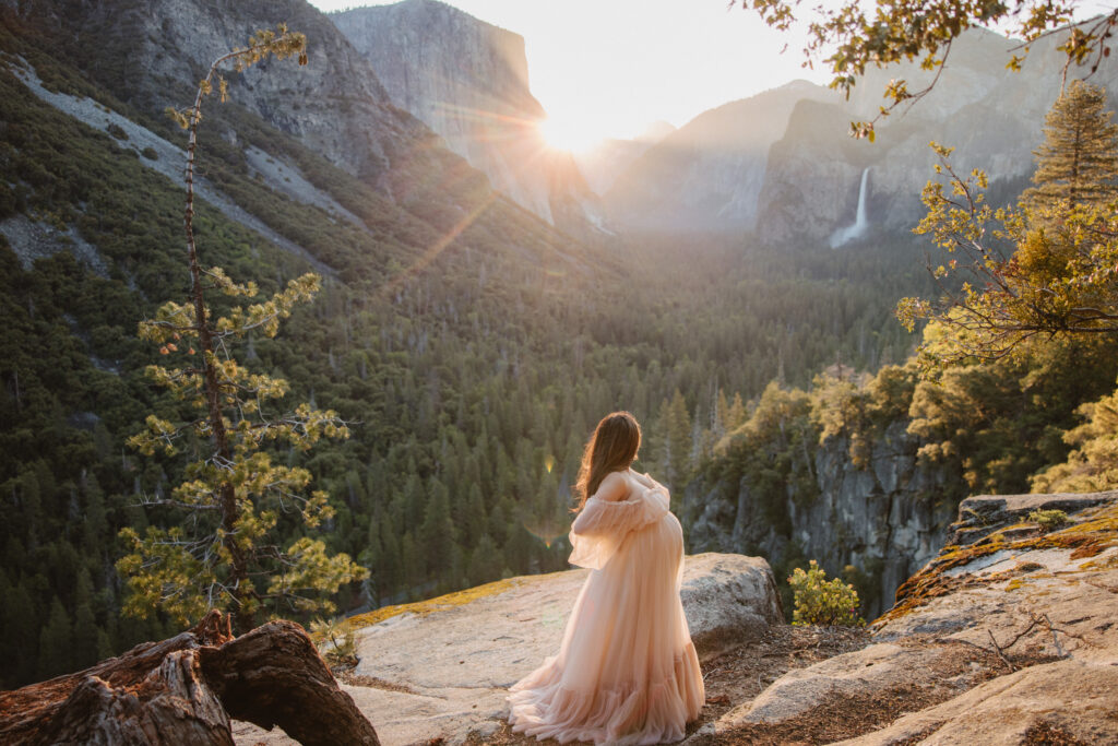 couple posing in the mountains for their maternity photos