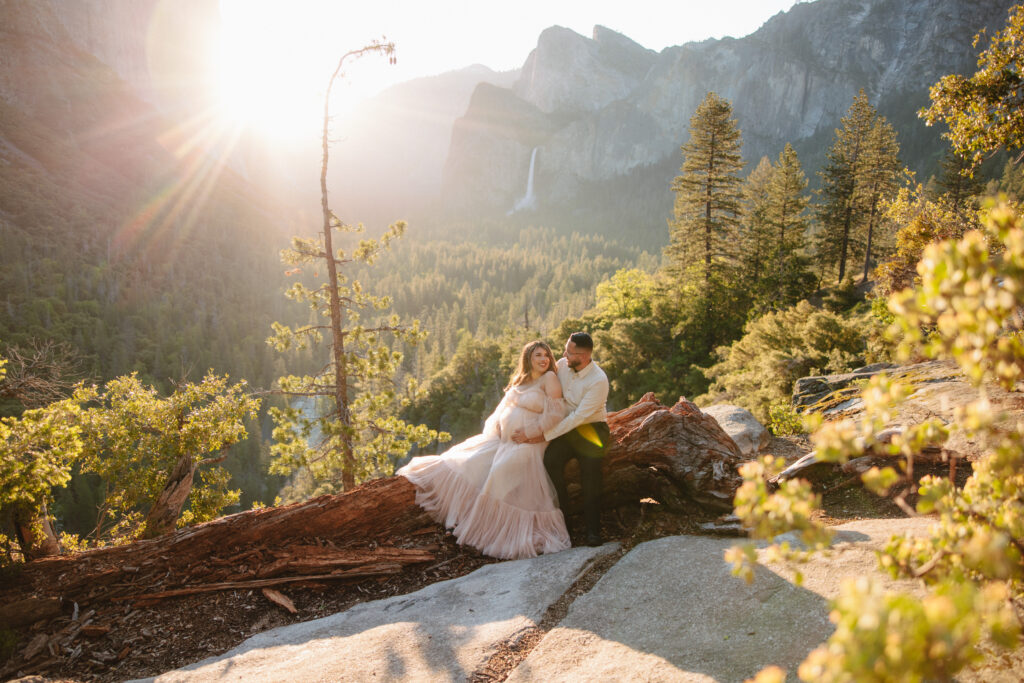 couple posing in the mountains for their maternity photos
