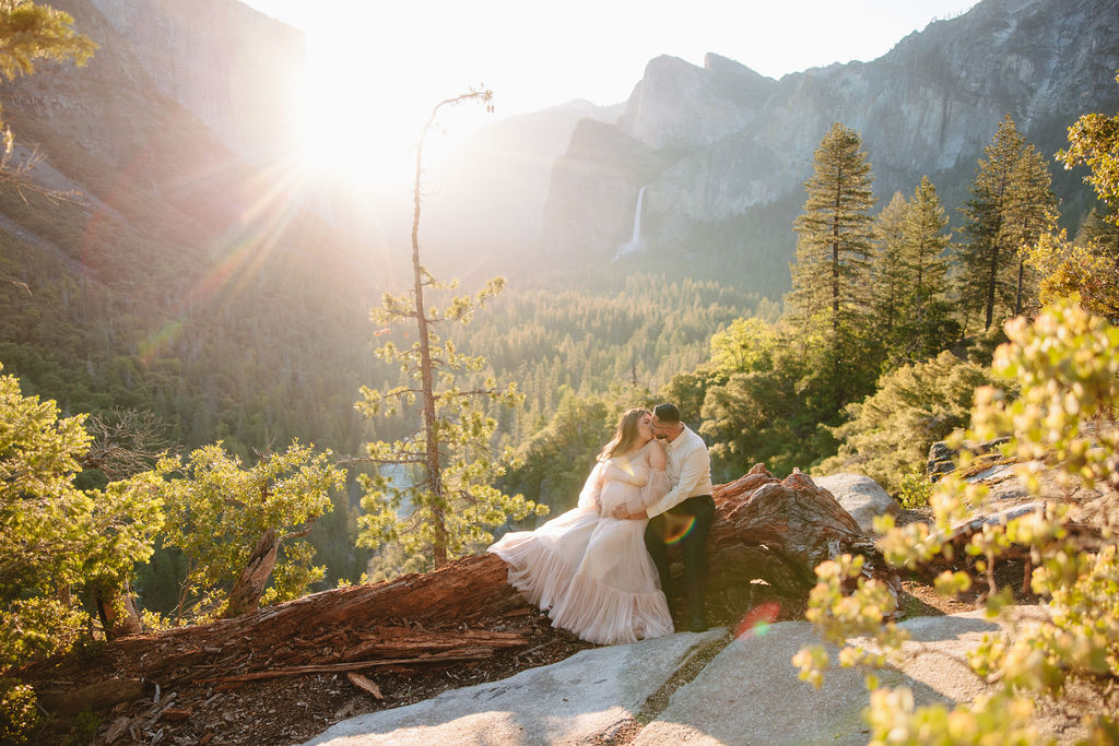 couple kissing during photoshoot in the mountains