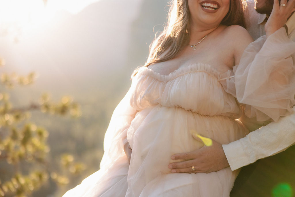 couple posing for a maternity session outdoors
