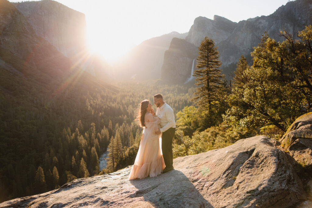 couple posing in the mountains for their maternity photos
