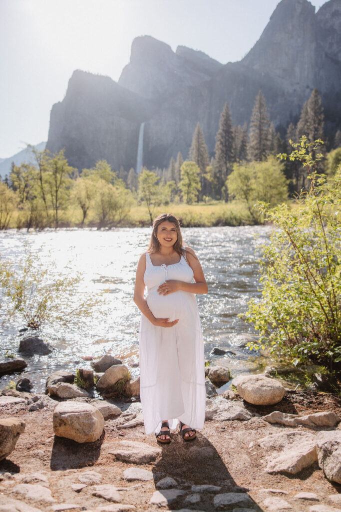 couple posing in the mountains for their maternity photos
